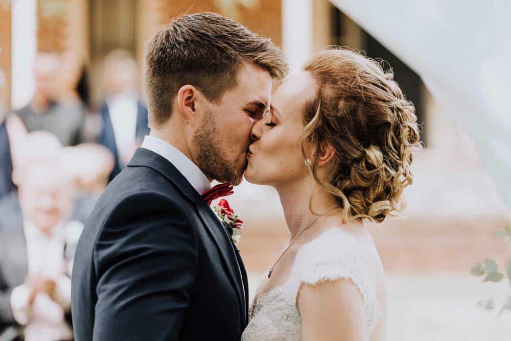 bride and groom share first kiss during outdoor ceremony captured by james white hunter valley wedding photographer