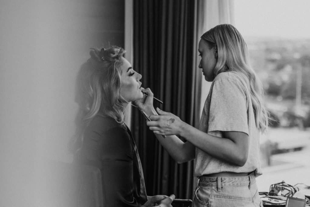 makeup artist doing bridesmaid before wedding captured by james white photography