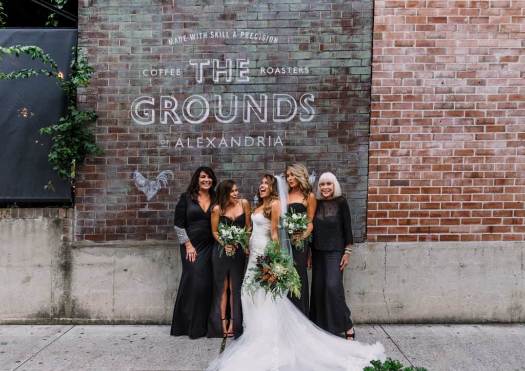 bride, bridesmaids mother and grandmother all together for photo at grounds of alexandria captured by james white photography