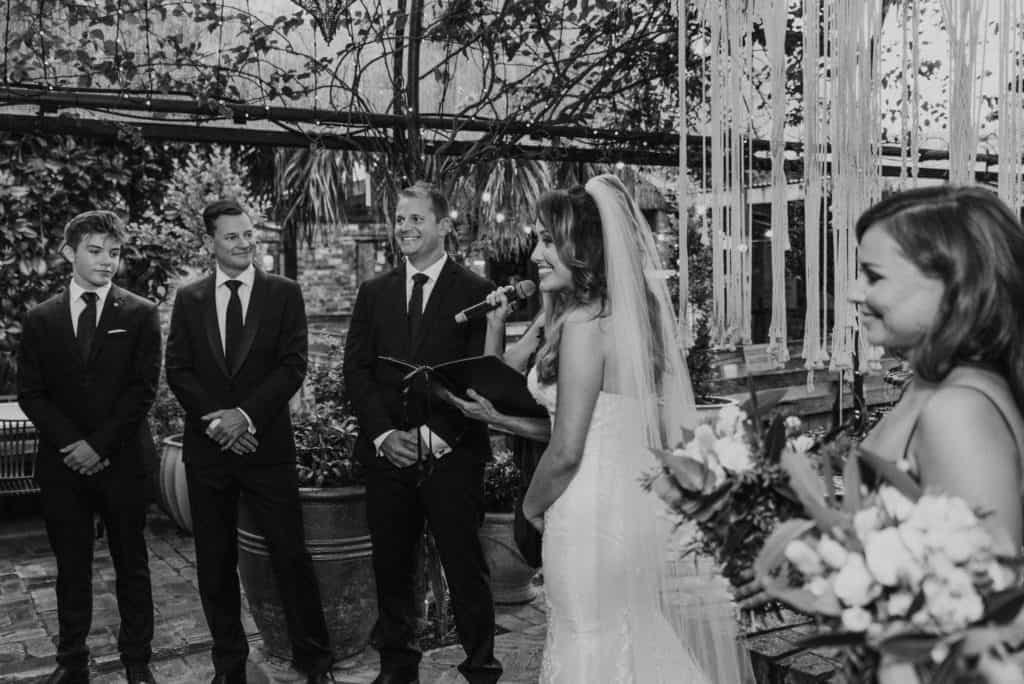 bridal party exchanging vows at grounds of alexandria wedding captured by james white photography