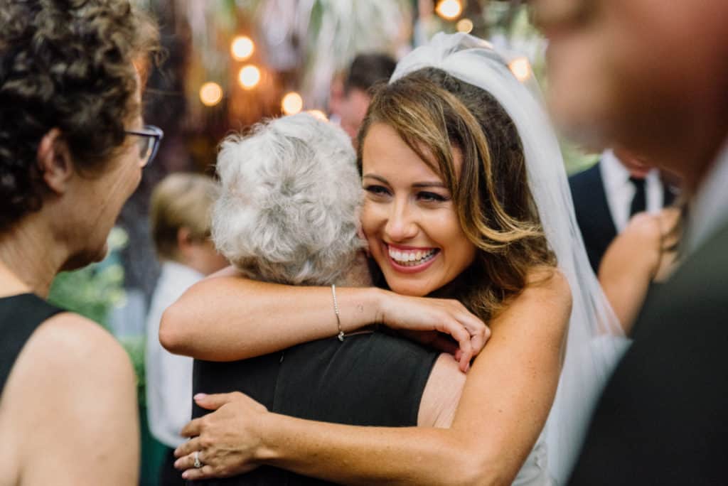 bride greets grandmother after wedding ceremony captured by james white photography