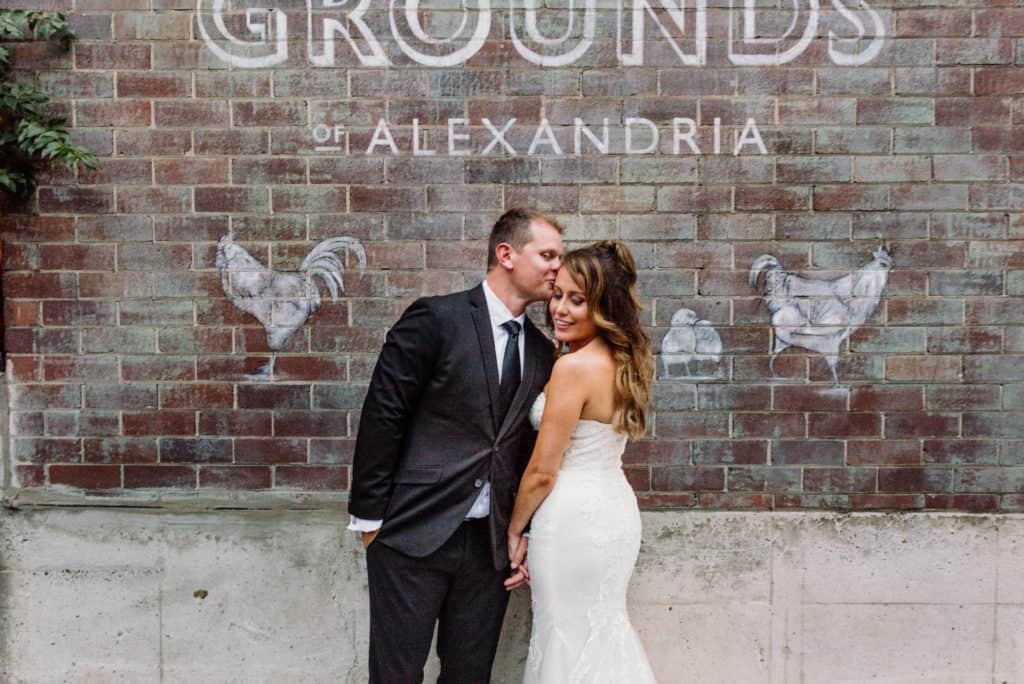 bride and ground against old brick wall at grounds of alexandria captured by james white photography