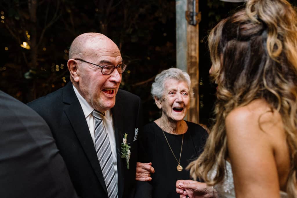 bride talking to grandparents at wedding reception captured by james white photography
