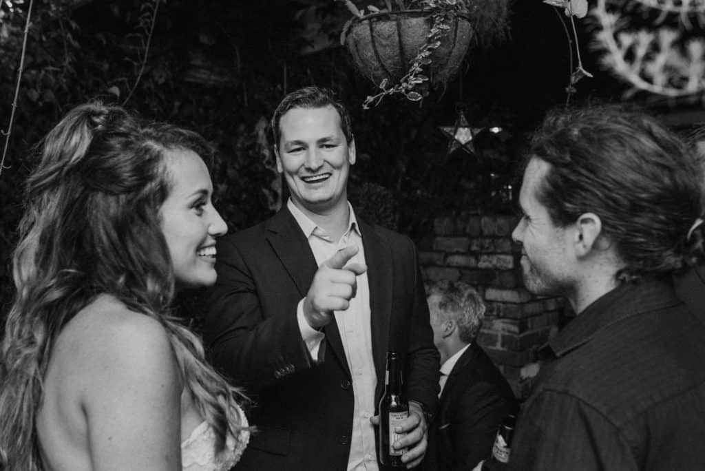 guests joking and laughing at reception captured by james white photography