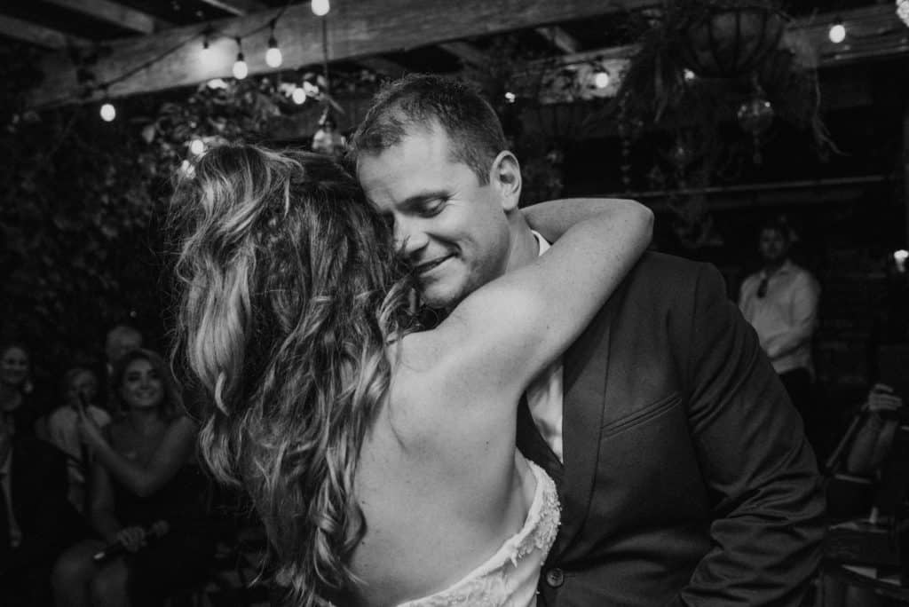 first dance as groom kisses bride under the stars captured by james white photography