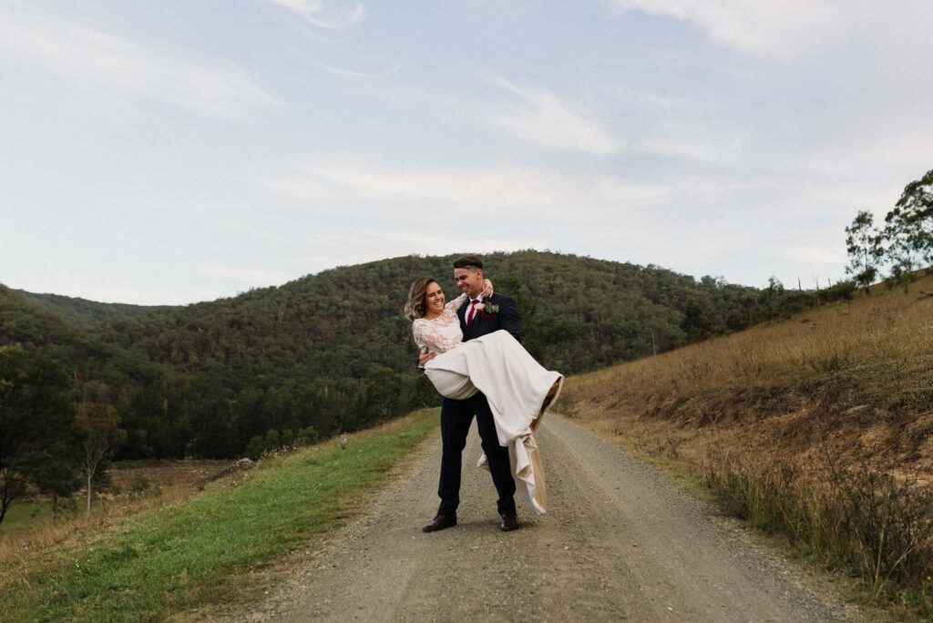 groom picks up bride and spins her around at stonehurst hunter valley wedding venues favourites
