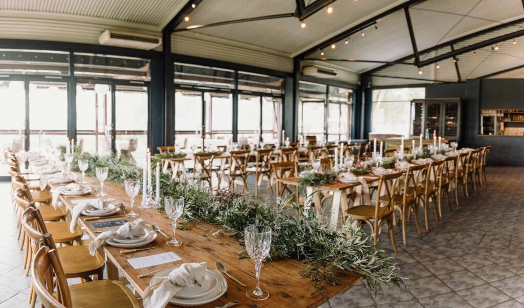 long wooden table setup, covered in natural green runner at estate tucany captured by james white hunter valley wedding photographer