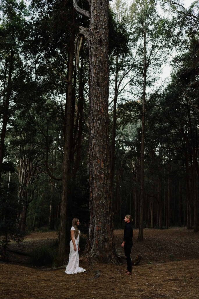 bride and groom walking towards one another in the watagans pine forest wedding venu central coast