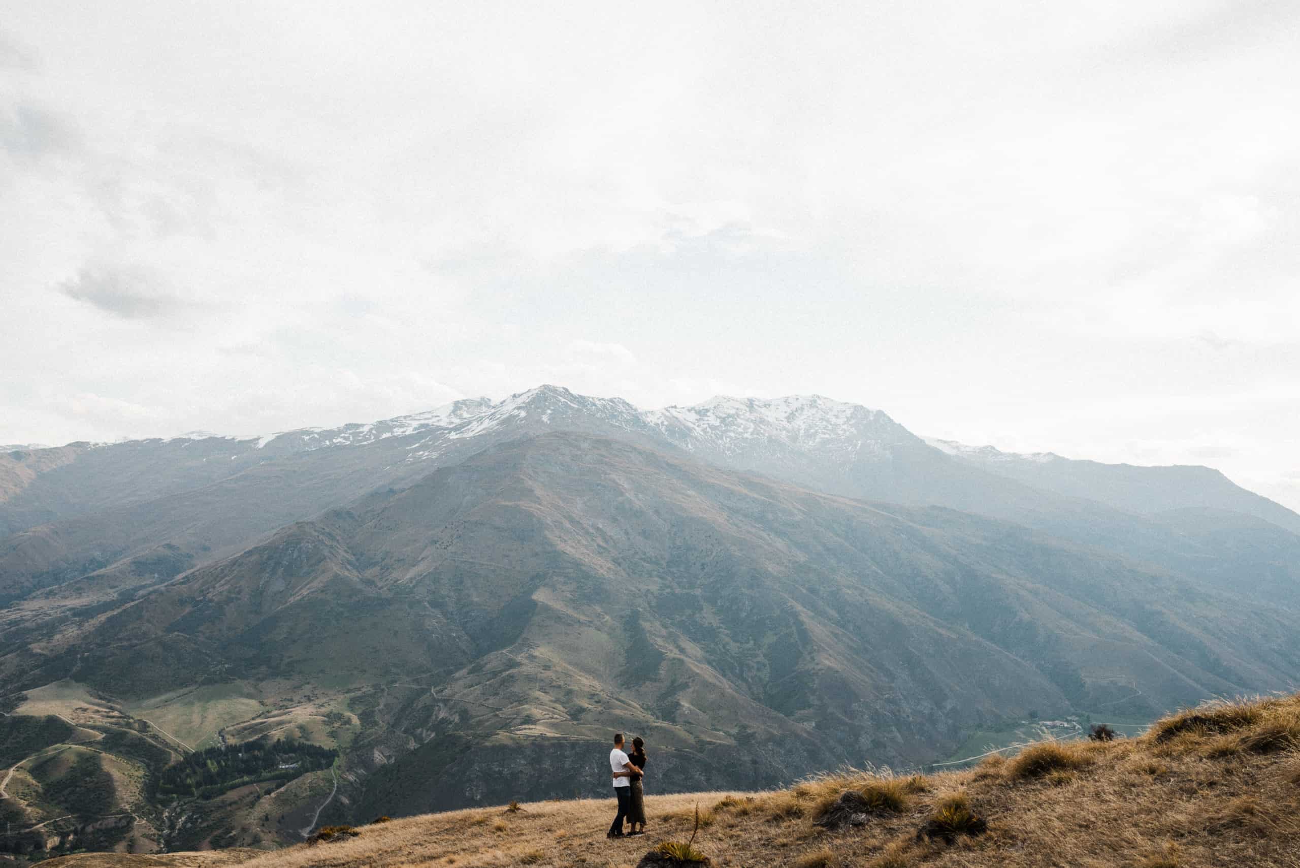 bride and groom in casual clothing elope on mountain in wanaka new zealand