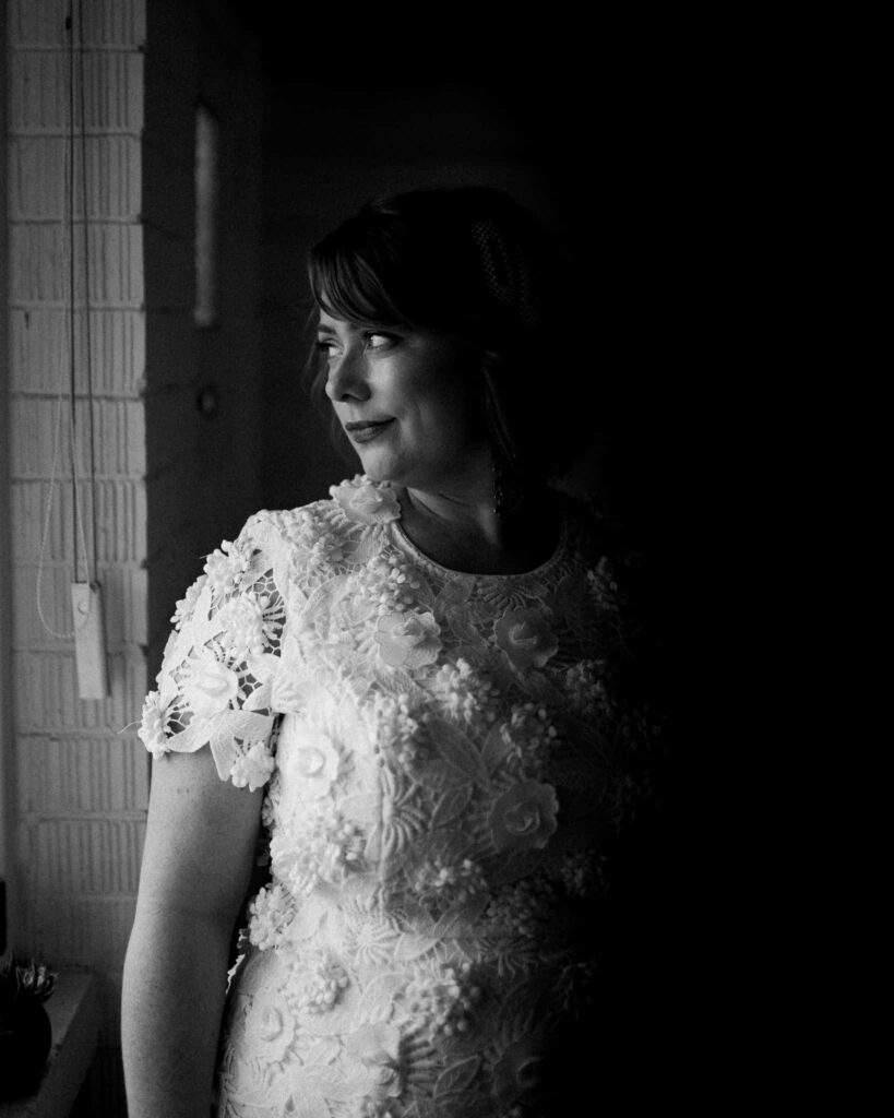 beautiful elegant shot of bride in front of window before wedding ceremony captured by james white newcastle wedding photographer