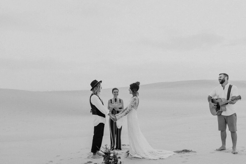Elopement ceremony, best place to sloep at stockton sand dunes. Couple share wedding vows