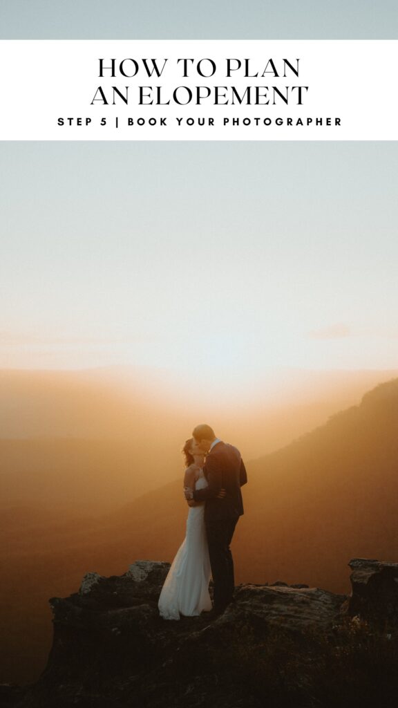 How to plan an elopement, step 5, book a photographer. Bride and groom standing on the edge of a cliff, on top of a mountain at sunset as the sun washes in behind them over the valley in the Blue Mountains